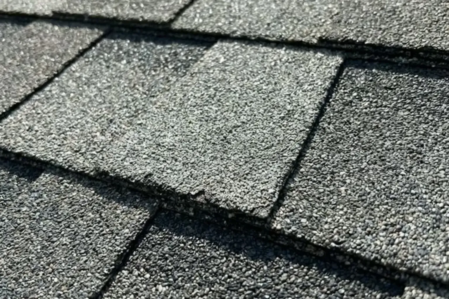 Documentary-style iPhone photo of completed residential roof with new architectural shingles in Provo, Utah. Natural daylight.