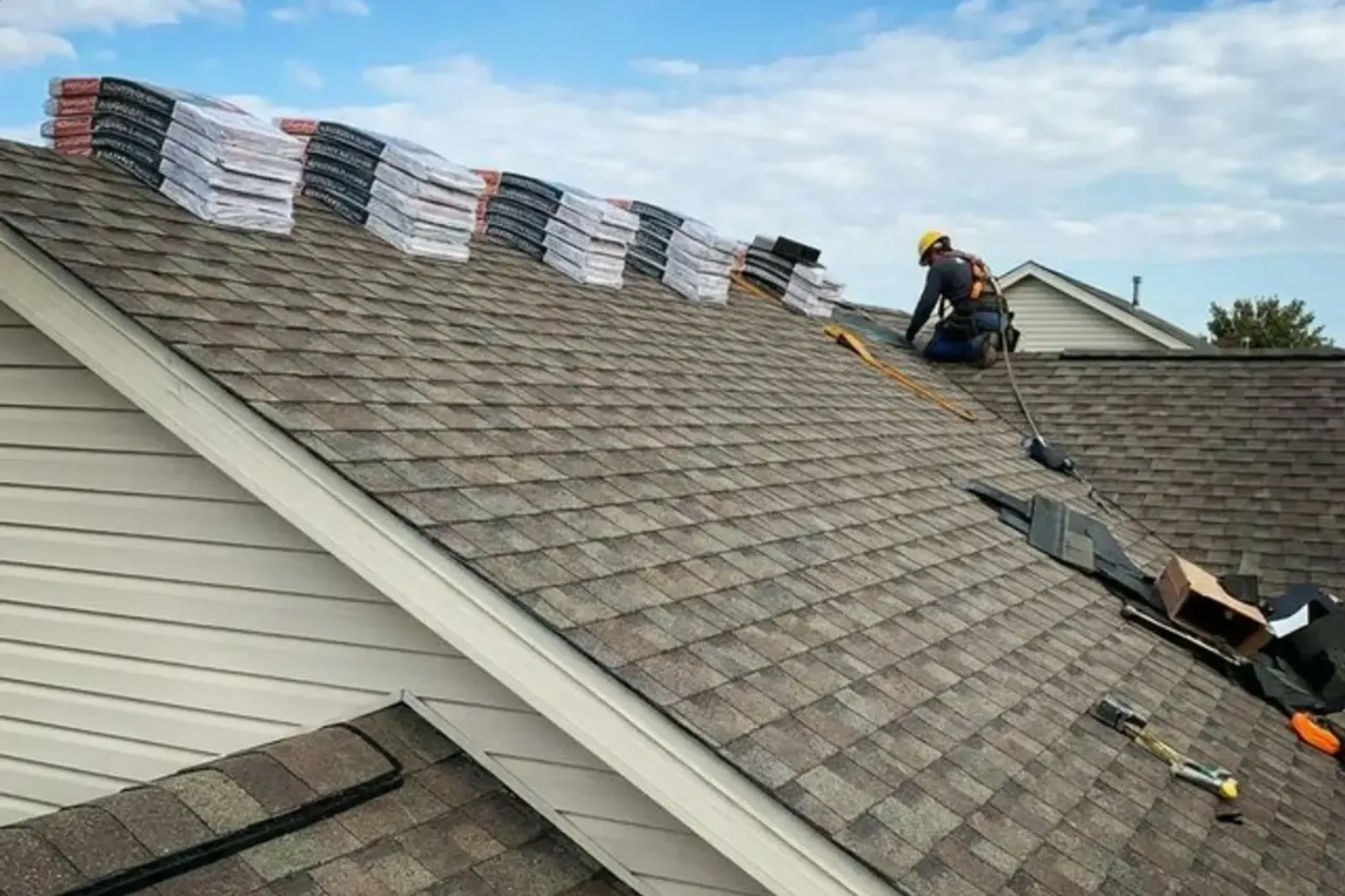 Documentary-style iPhone photo of new asphalt shingle installation on a residential home in Provo, Utah. Natural daylight.