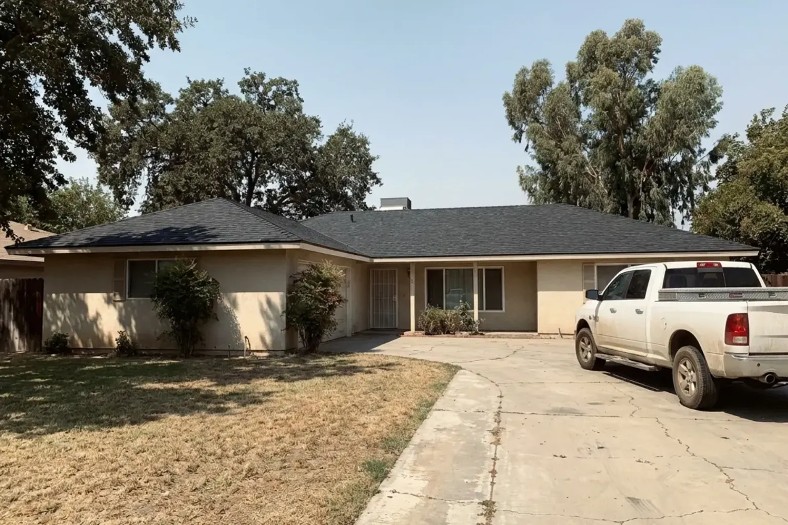 Documentary-style iPhone photo of completed roof replacement on a Provo, Utah home with new architectural shingles. Natural daylight.