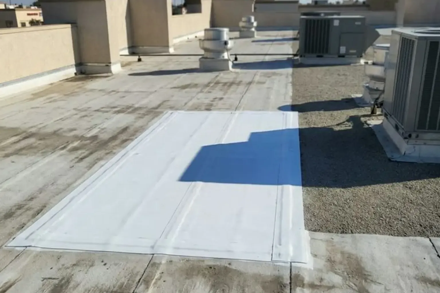 Documentary-style iPhone photo of emergency commercial roof tarping and temporary weatherproofing after storm damage in Provo, Utah. Natural lighting.