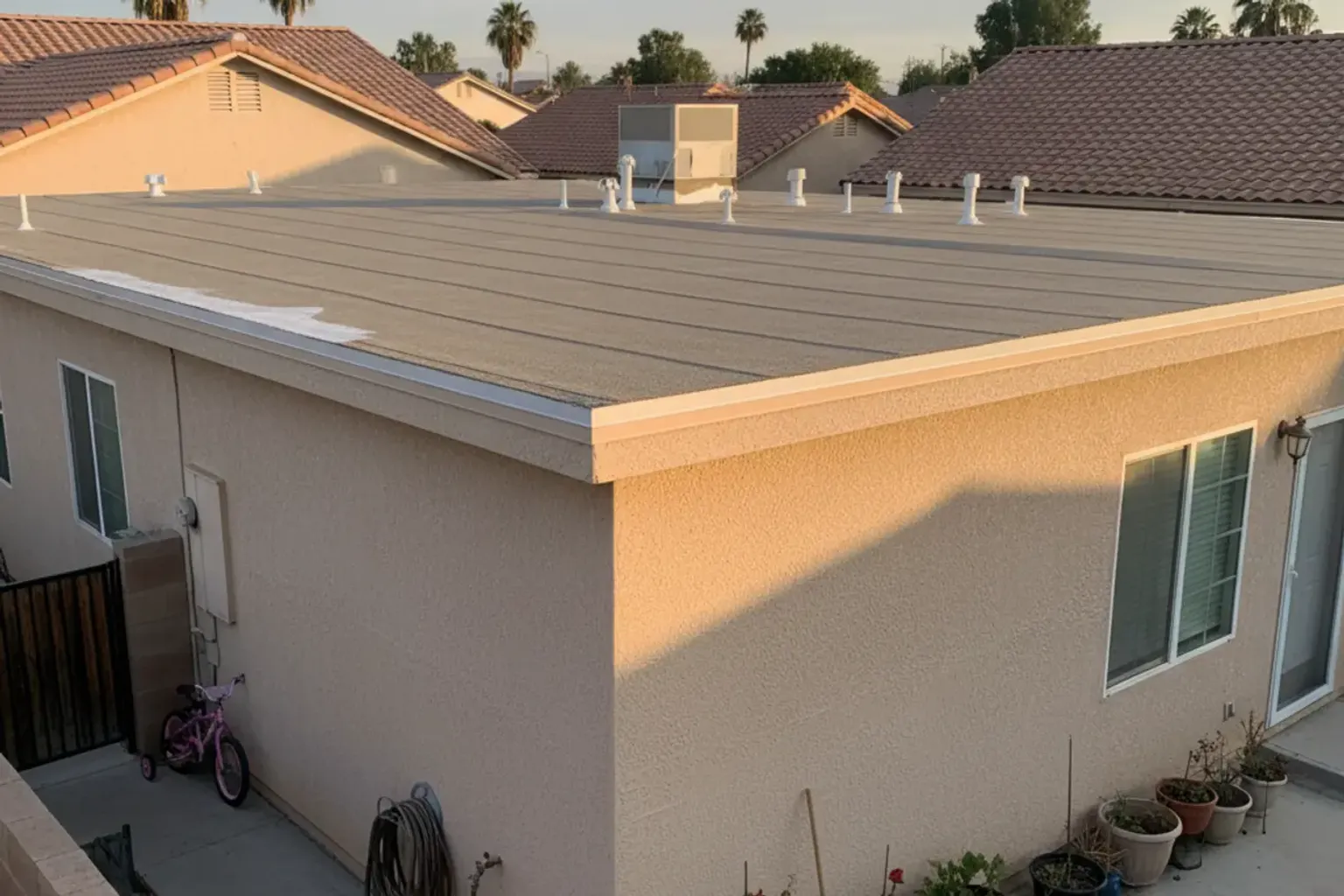 Documentary-style iPhone photo of TPO membrane repair work on a commercial flat roof in Provo, Utah. Natural daylight.